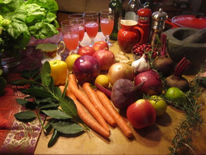 Image of drinks, vegetables, herbs, fruits, salt and pepper grinders, a mortar and pestle, and a pot